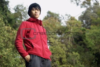 Confident asian man outdoors in red