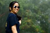 Happy asian malay teen lady with sunglasses outdoors