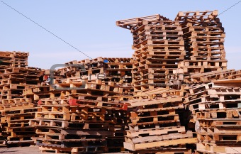 Used wooden pallets  stacked under open sky