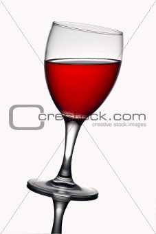 Leaning wine glass with red wine 