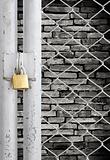 Chain link fence and metal door with lock see grunge wall background