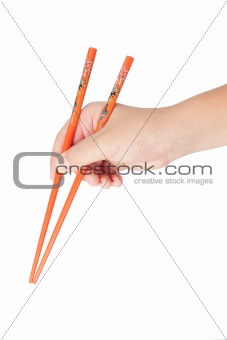 Boy's hand holding Japanese chopsticks 