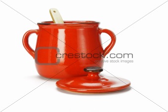 Open red clay pot with wooden ladle 