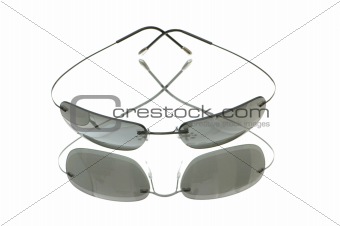 Stylish sun glasses on highly reflective background