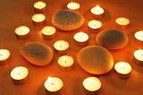 Burning candles and pebbles for aromatherapy session