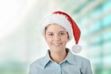 Young business woman in santa hat