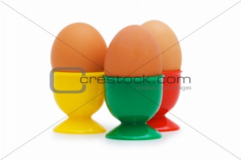 Brown egg in holder isolated on white