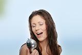 Young woman singing under shower