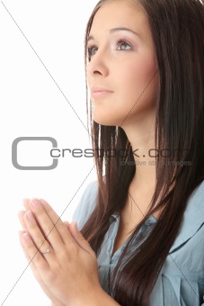 Closeup portrait of a young caucasian woman praying isolated on white background

