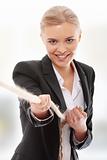 Businesswoman pulling on a piece of rope