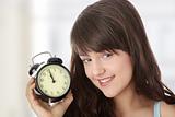 A teen woman with alarm clock