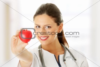 Young nurse with heart in her hand