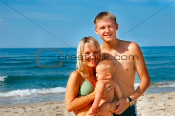 young happy family on beach