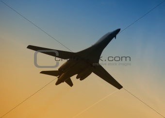 Military aircraft in flight at dawn