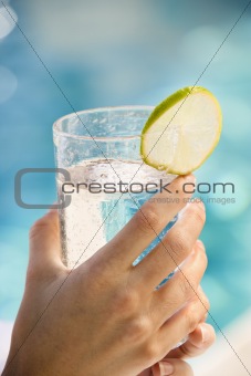 Hands holding drink.