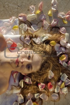 Woman lying on petals.