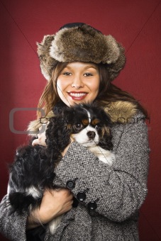 Woman holding dog.