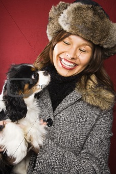 Woman holding dog.
