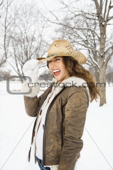 Woman tilting hat.
