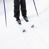 Skier legs on slope.