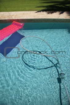 Float and vacuum in pool.