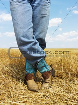 Cowboy standing in field.