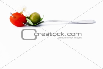 Ham, tomato and fresh basil leaf on silver fork