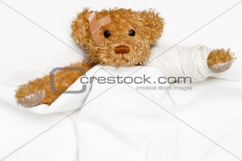 Teddy bear as a patient in hospital's bed