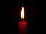 The red candle burning in full darkness