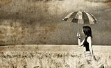 Girl with umbrella at field. Photo in old retro style. 