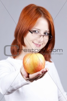 Girl with apple in hand. Studio shot.