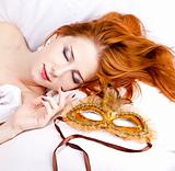 Sleeping woman near carnival mask.