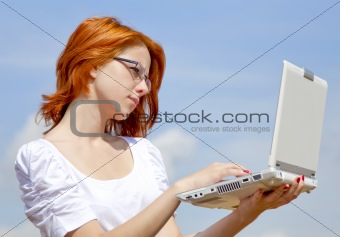 Young Businesswomen in white keeping laptop