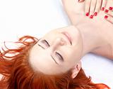 Close-up beautiful fresh young lady in studio shot with red hair