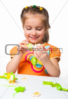 Happy little girl with easter egg
