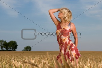 beautiful woman standing in wheat field