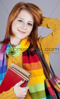 Young student girl with books.