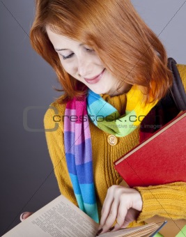 Young student girl with books.