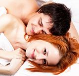 Young attractive happy amorous couple at bedroom 