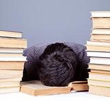 The young tired student with the books isolated.