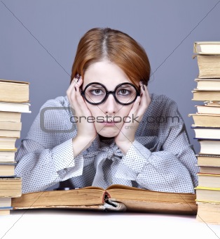The young teacher in glasses with books. 