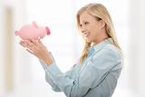Businesswoman holding piggy bank