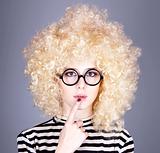 Portrait of funny girl in blonde wig. 