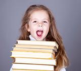 Little school girl with books. 