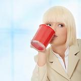 Business woman holding cup of coffee