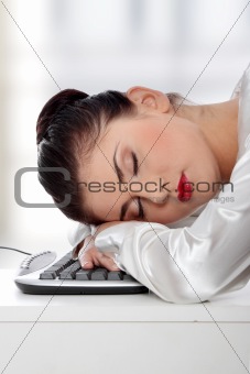 Businesswoman sleeping on the keyboard