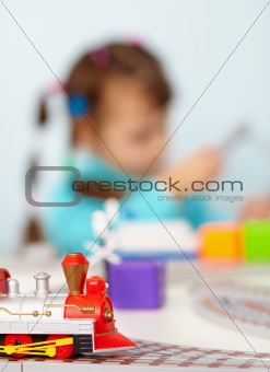 Child playing with toy railway