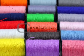 lot of colored thread spools