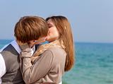 Couple kissing at spring sea.