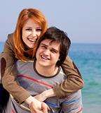 Portrait of a happy young couple having fun on the beach. 